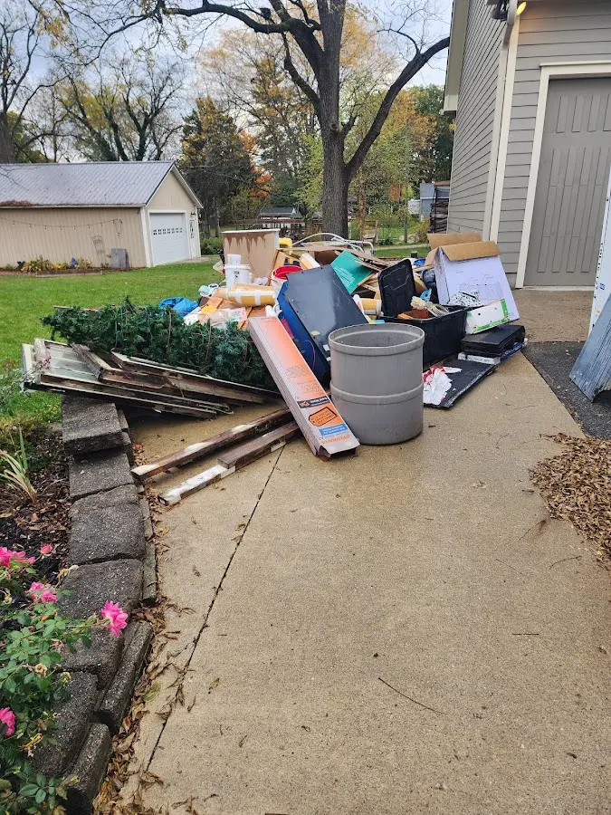 Dumpster being loaded with debris for Estate Cleanout Dumpster Rental in West Monroe